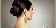 A beautiful chignon that has been styled by Get Glossy.