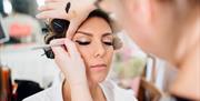Eyeliner expertly being applied to a model's eyes