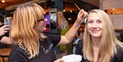 A smiling model having gorgeous make up applied to their face.
