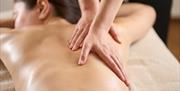 A person laying down having a relaxing massage