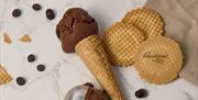 A chocolate ice cream cone lying on a marble surface