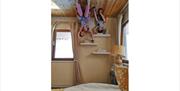 Children on shelves in bedroom