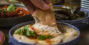 Flatbreads and dips being enjoyed.