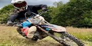 Rider on a bike on woodland terrain