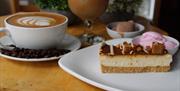 A cup of coffee and slice of cake.