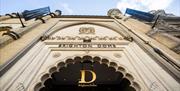 The exterior main entrance of Brighton Dome, the shot is taken looking up toward the Dome sign above an intricate doorway.