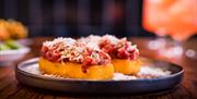 A plate with a tomato and potato dish.