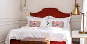 White linen on a comfy-looking king sized bed