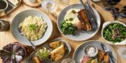 Delicious looking dishes on a table at One Kitchen