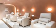Treatment chairs for pedicures lined up.