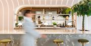 A client walking in front of the bar area