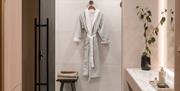 A fluffy robe hanging on the wall.