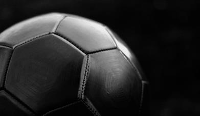 Black football on dark background