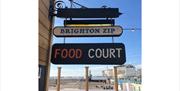 The Brighton Zip Food Court sign