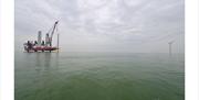 rig with wind turbine at sea