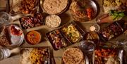 A table showing a feast of dishes at Mowgli Brighton.