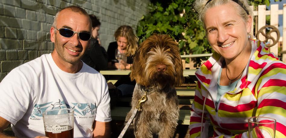 Dog Friendly Bristol - Dog in a pub garden with it's owners: Credit Liz Myers