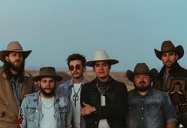 A group of men wearing denim jackets and cowboy hats