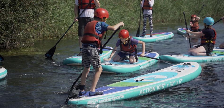 Children Stand Up Paddleboarding at Mendip Activity Centre