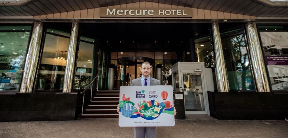 Staff from Mercure Holland House holding a Bristol Gift Card outside the hotel