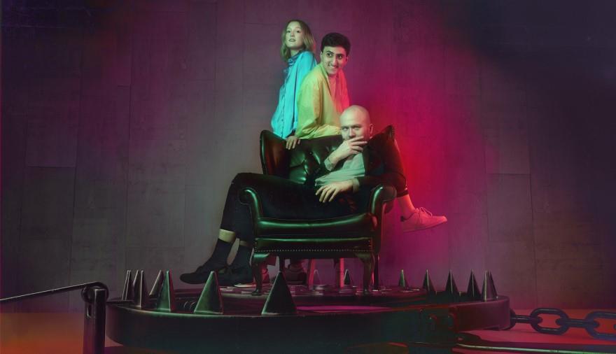 Three men on a chair on top of a bear trap