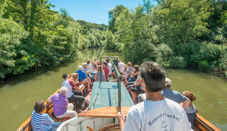 People on board a Bristol Packet boat on the river