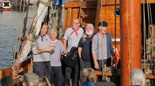 Five men singing sea shanties on Matthew in Bristol