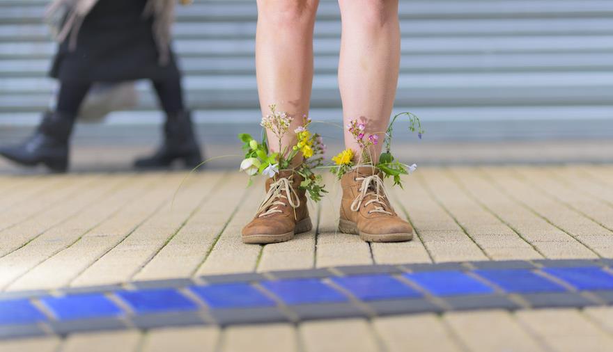 A person with flowers in their boots