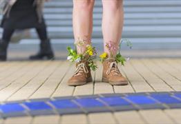 A person with flowers in their boots