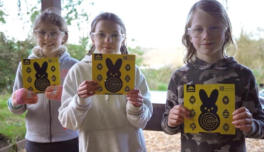 Children holding air rifle targets