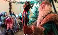 Festive Fables at Bristol Zoo project - green santa with family in the background