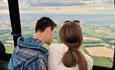 Couple looking out from hot air balloon