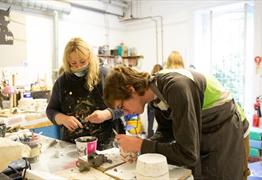 2 people in a clay studio