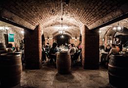 People dining in underground wine cellars