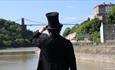 Brunel with hat on looking at bridge