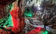 Wookey Hole caves illuminated in red and green
