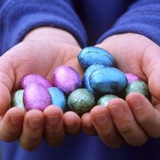 Hands holding colourful chocolate Easter eggs