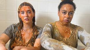 2 girls stat in a bath tub covered in spaghetti 