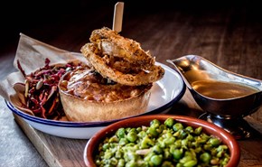 Pieminister pie with gravy, peas, slaws and onion rings