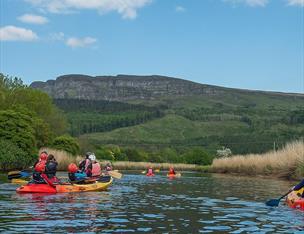kayaking on the river roe with binevenagh in the background