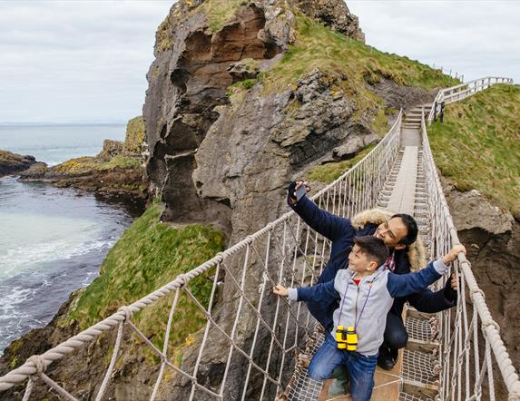 Father and Son on Carrick-a-Rede Rope Bridge taking a selfie