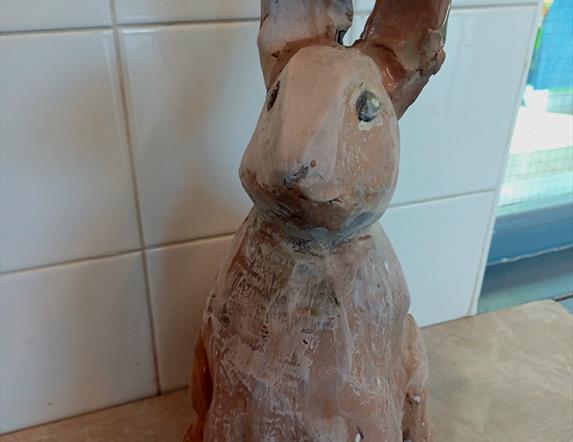 A brown hare sculpted entirely from clay.