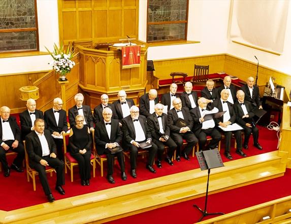 image of Ballymoney & District Male Voice Choir seated in a church