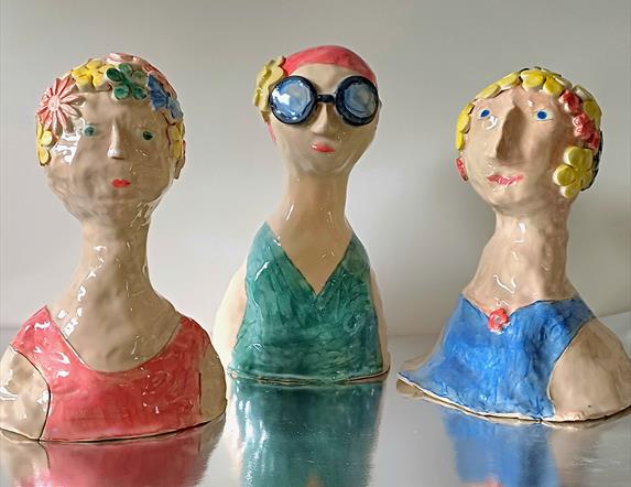 Three ceramic "Sea Swimmer" decorations, depicting various old fashioned bathing suits.