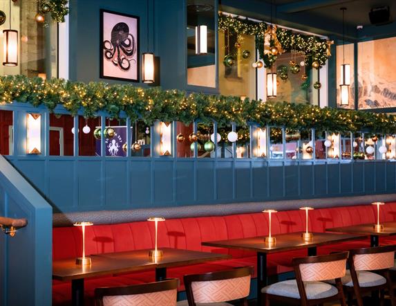 interior of Nemesis Asian Fusion restaurant decorated for Christmas with festive garlands