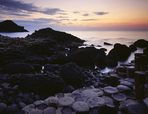 Picture of the Giant's Causeway at sunset - the rocks with the waves in the distance