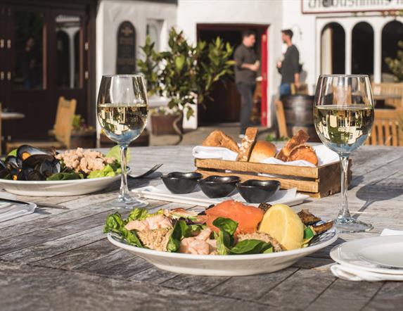 Food and wine on an outside table behind the Bushmills Inn.