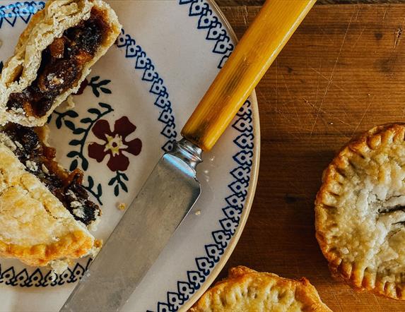 mince pies on a plate and table