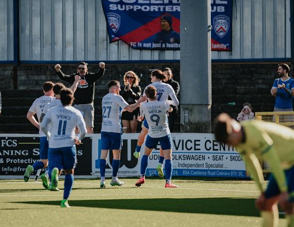Coleraine FC celebrating on the pitch.