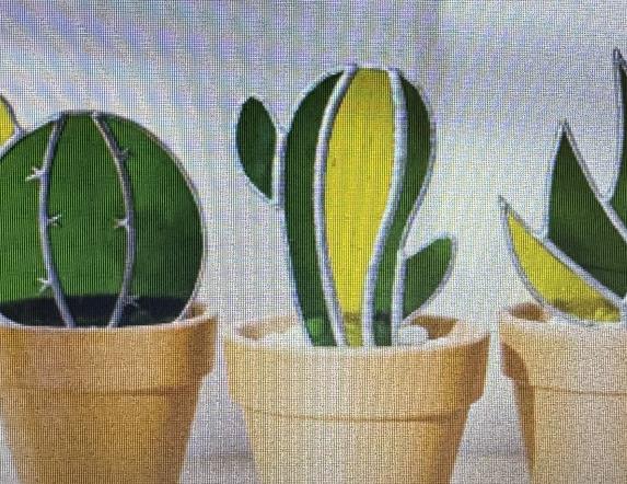 3 glass cacti potted next to each other against a white background.